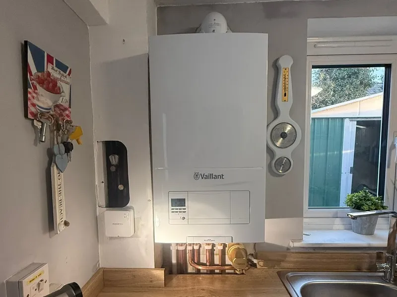 Vaillant boiler being serviced in a kitchen
